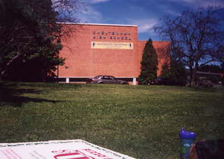 CHS XC high school building with pizza box in foreground