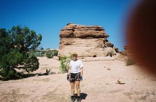 Arches National Park -- Adam -- D. Arch trail -- finger over lense