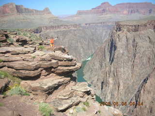 93 5t8. Plateau Point -- Mighty Colorado River -- Adam on rock ledge