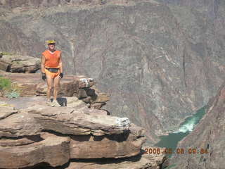 96 5t8. Plateau Point -- Mighty Colorado River -- Adam on rock ledge