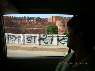 205 69e. Agra Fort out the car window - Sudhir in silhouette