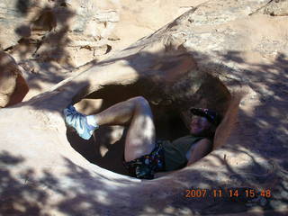 227 6be. Arches National Park - Devils Garden hike - Adam in hole in rock