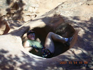 228 6be. Arches National Park - Devils Garden hike - Adam in hole in rock