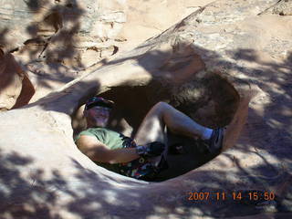 231 6be. Arches National Park - Devils Garden hike - Adam in hole in rock