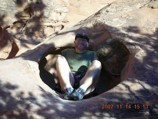 232 6be. Arches National Park - Devils Garden hike- Adam sitting in hole in rock