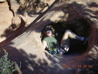 244 6be. Arches National Park - Devils Garden hike - Adam in hole in rock