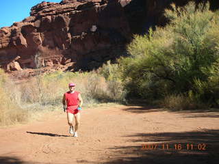 183 6bg. Canyonlands National Park - Lathrop Trail hike - Adam (tripod) running