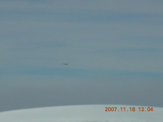 airplane flying over canyon