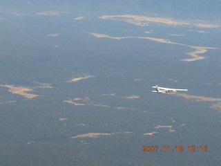 airplane flying over canyon area