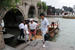 12 6l8. eclipse - China - Gordon - Zhu Jia Jiao fishing village boat ride - Jacky helping Adam off