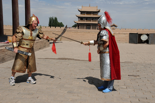 25 6l8. eclipse - China - Gordon - Adam and Wendy as warriors at Great Wall fort