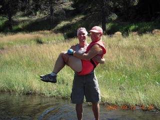 Dustin carrying Adam across river - hiking at Pine Valley, Utah