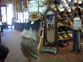 Jane trying on cowboy hat with Abigail in mirror