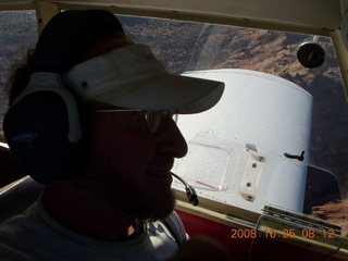 Adam flying N4372J in silhouette