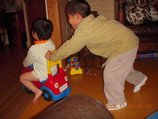 Cecelia and Gaby riding the toy truck