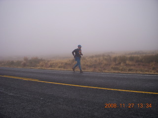 Canyonlands National Park - Lathrop trail hike - Adam running on the road in the rain