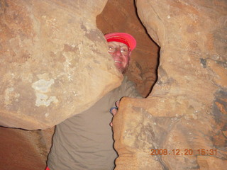 90 6ql. Zion National Park - Angels Landing hike - Adam peeking through rock in Refrigerator Canyon