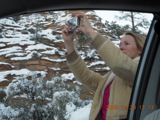 133 6ql. Zion National Park- Debbie taking a picture seen from the car