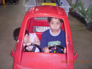 Cecelia and Gaby in shopping-cart car