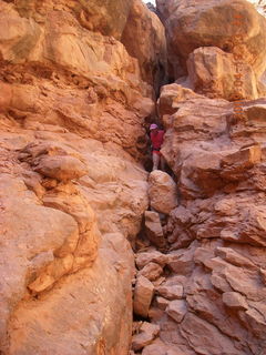 Arches National Park - Adam squeezing through Squeeze Through Arch - Fiery Furnace hike