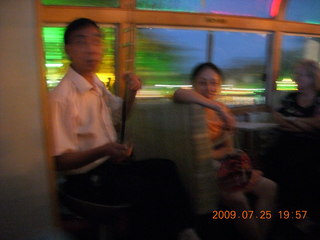 302 6xr. China eclipse - Guilin evening boat tour - musician on odd instrument