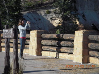 Bryce Canyon - young lady taking picture of raven