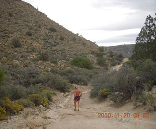 Canyonlands Lathrop Trail hike - Adam running on white rim road - back