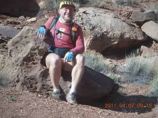 52 7j7. Canyonlands Lathrop hike - Adam sitting on neat rock (tripod)