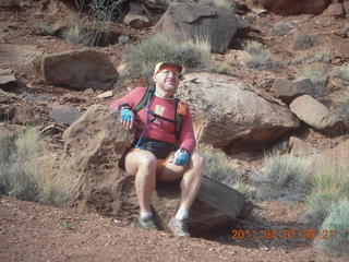 54 7j7. Canyonlands Lathrop hike - Adam sitting on neat rock (tripod)