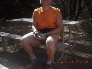 130 7j7. Canyonlands Lathrop hike/run - Adam at riverside picnic table at (tripod)