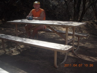 132 7j7. Canyonlands Lathrop hike/run - Adam at riverside picnic table at (tripod)