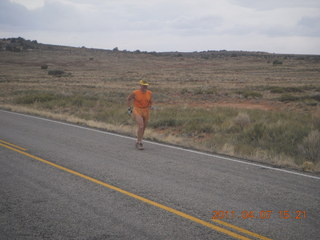 Canyonlands Lathrop hike/run - Adam running with sign