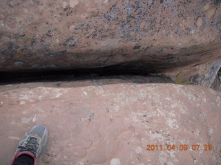 42 7j9. Arches Devil's Garden hike - gap in rock with litter