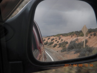 134 7j9. Arches National Park drive - view in mirror (trying to get bike rider)