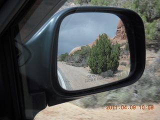140 7j9. Arches National Park drive - view in mirror (trying to get bicyclists)