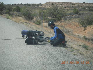 157 7j9. drive to Dead Horse Point - cyclist changing a tire (No, he didn't need help.)