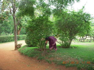 India - Auroville - woman with short-handle broom