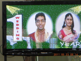 55 7kp. India - Puducherry (Pondicherry) - Randeep's wedding - looking dour on TV screen