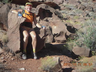62 7qb. Canyonlands National Park - Lathrop trail hike - Adam sitting in 'rock chair'
