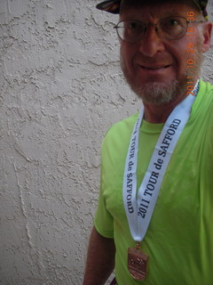 Adam with shirt and medal from Safford half-marathon race