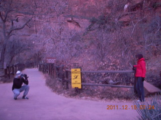 13 7sf. Zion National Park - pre-dawn Riverwalk - icy warning signs, Gokce taking a picture of Olga