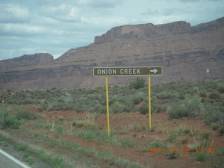 176 7x2. driving on Route 128 to Onion Creek - sign