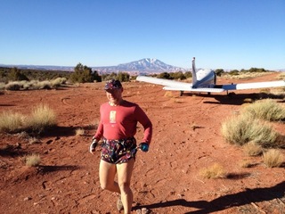 325 7zl. Tony's picture of N8377W at Nokai Dome airstrip with Adam running