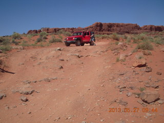 115 89t. Chicken Corner drive - my red Jeep driving down a hill