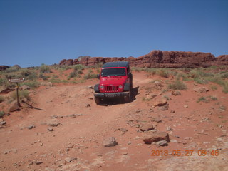 121 89t. Chicken Corner drive - my red Jeep driving down a hill