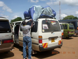 54 8f1. Uganda - drive north to Chobe Sarari Lodge - our driver Raphael adjusting our bags