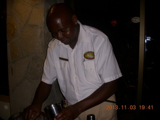 1 8f4. Uganda - Chobe Sarafi Lodge - after-eclipse drink server