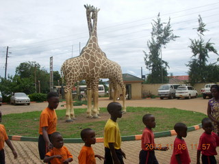 183 8f8. Uganda - Entebbe - Uganda Wildlife Education Center (UWEC) - school children and giraffe sculpture