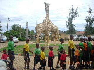 184 8f8. Uganda - Entebbe - Uganda Wildlife Education Center (UWEC) - school children and giraffe sculpture