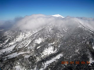 aerial - Humphries Peak with snow and clouds